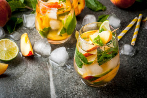 Summer refreshment drinks. Peach mojito with lime, peach and min